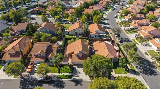 an aerial view of a house with a yard and lake view