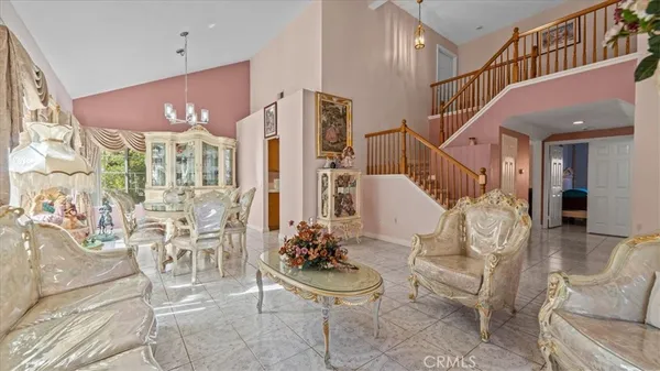 a living room with furniture and a chandelier