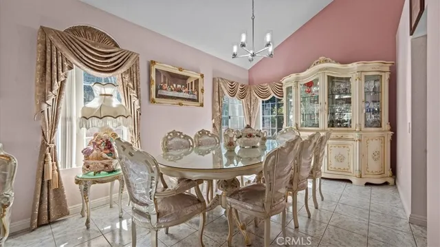 a view of a dining room with furniture and chandelier