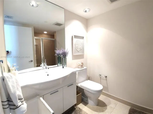 a bathroom with a sink toilet a mirror and vanity