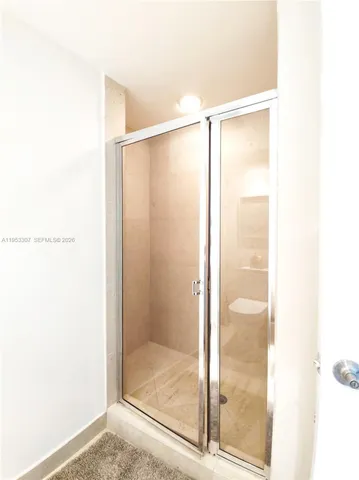 a bathroom with a glass shower door