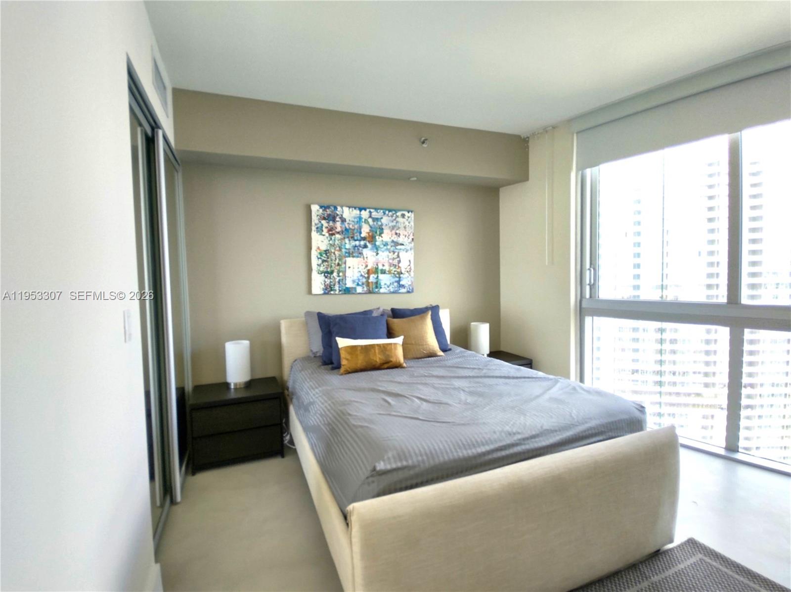 465 Brickell Avenue, Unit 4402 Miami, FL 33131 - Photo 20 of 33 a bed sitting in a bedroom next to a window