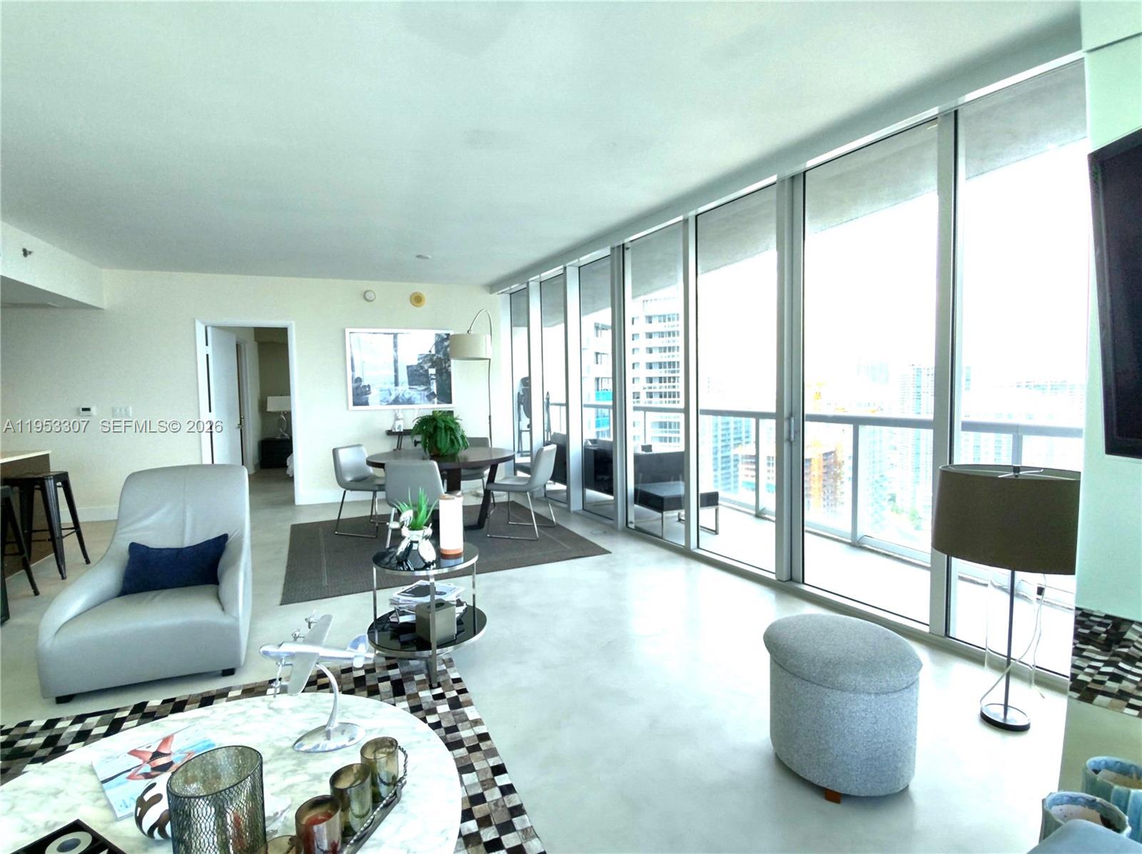 465 Brickell Avenue, Unit 4402 Miami, FL 33131 - Photo 5 of 33 a living room with furniture and a floor to ceiling window