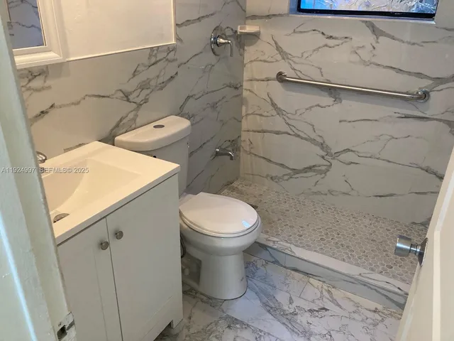 a bathroom with a toilet and a shower