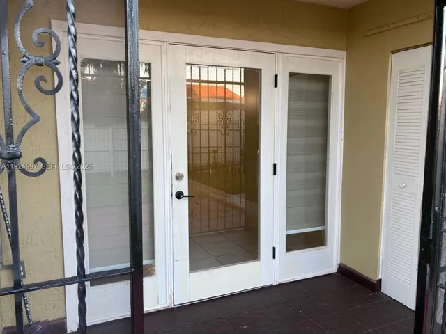 a view of empty room with wooden floor and wall