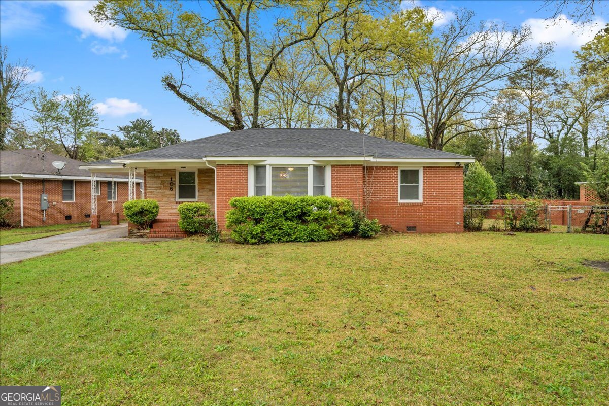 a front view of house with yard and green space