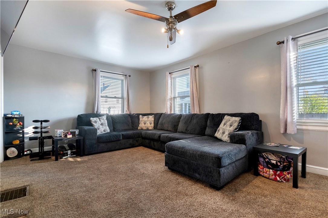 1361 Crescent Road Southwest Canton, OH 44710 - Photo 8 of 36 Carpeted living room with ceiling fan and baseboards