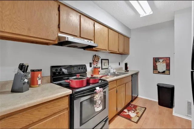 a view of a room that has a window and wooden floor