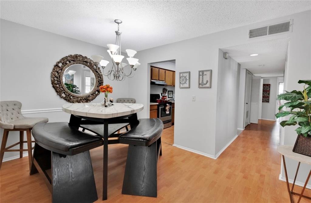 2411 Huntingdon, Unit 2411 Atlanta, GA 30350 - Photo 2 of 45 a view of a dining room with furniture and a chandelier