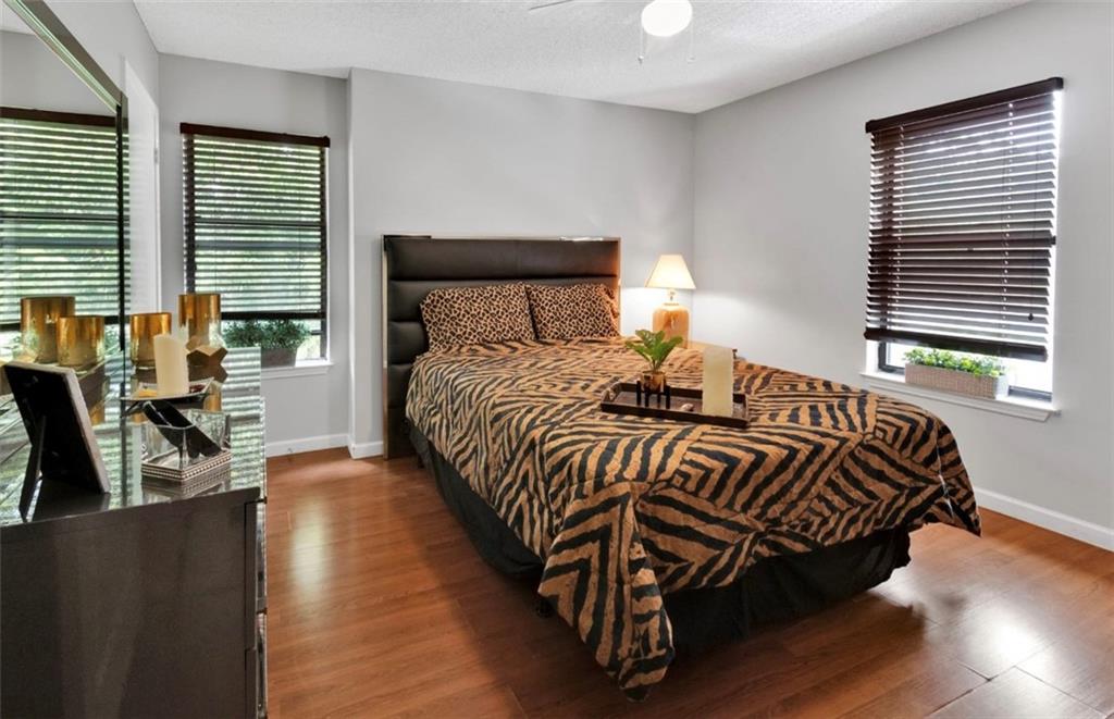 2411 Huntingdon, Unit 2411 Atlanta, GA 30350 - Photo 25 of 45 a bedroom with a bed and wooden floor