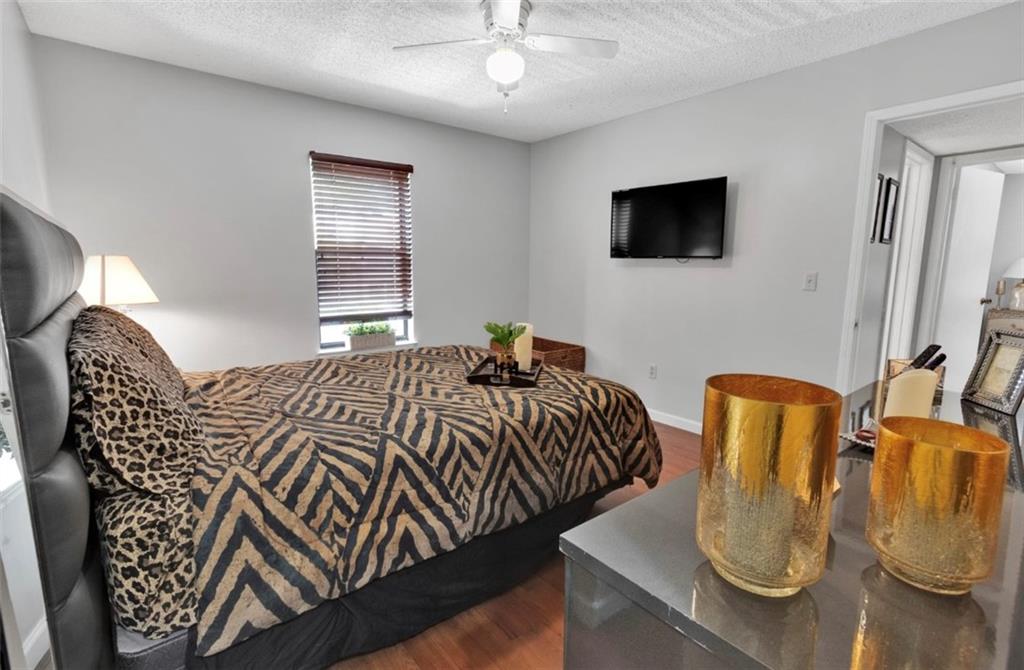 2411 Huntingdon, Unit 2411 Atlanta, GA 30350 - Photo 28 of 45 a bedroom with bed and flat screen tv