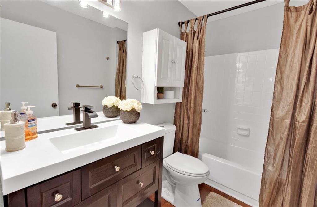 2411 Huntingdon, Unit 2411 Atlanta, GA 30350 - Photo 29 of 45 a bathroom with a sink vanity mirror and toilet