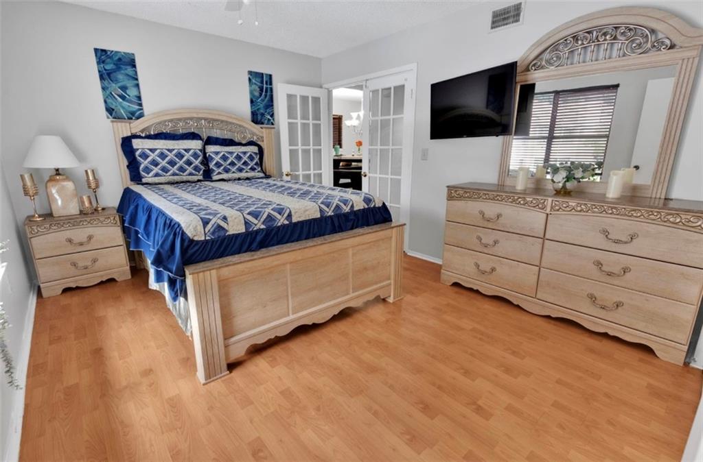 2411 Huntingdon, Unit 2411 Atlanta, GA 30350 - Photo 30 of 45 a bedroom with a bed and a flat screen tv