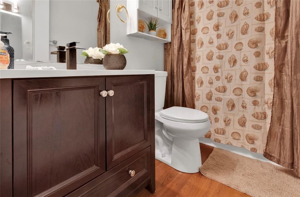 2411 Huntingdon, Unit 2411 Atlanta, GA 30350 - Photo 32 of 45 a bathroom with a sink toilet and mirror