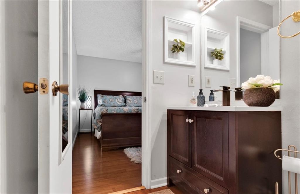 2411 Huntingdon, Unit 2411 Atlanta, GA 30350 - Photo 34 of 45 a bedroom with a bed and a mirror