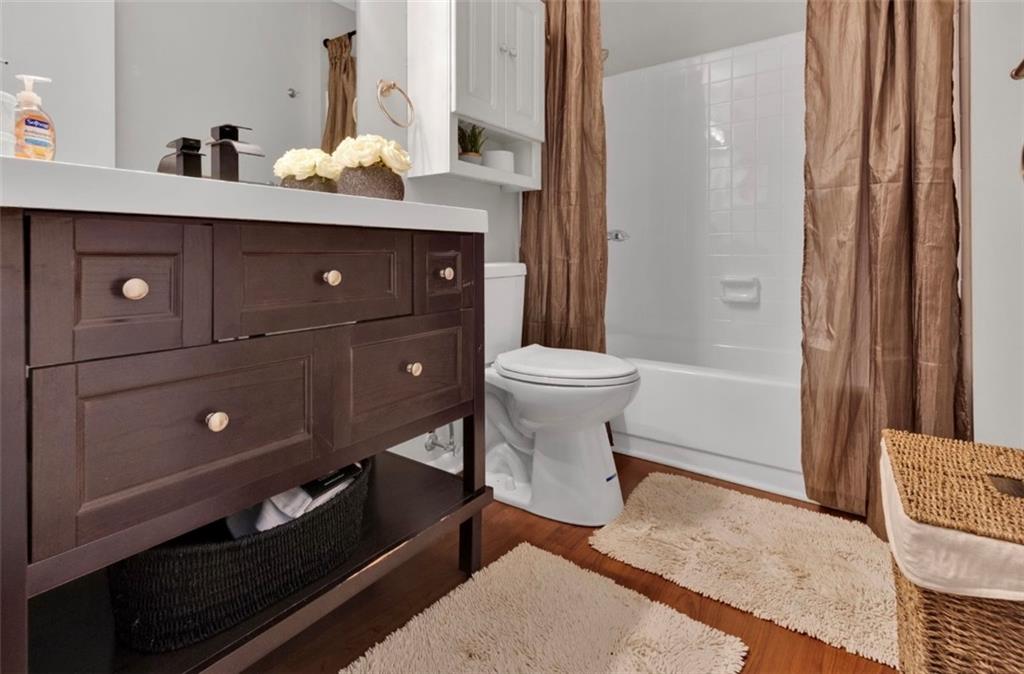 2411 Huntingdon, Unit 2411 Atlanta, GA 30350 - Photo 35 of 45 a spacious bathroom with a toilet a sink and mirror