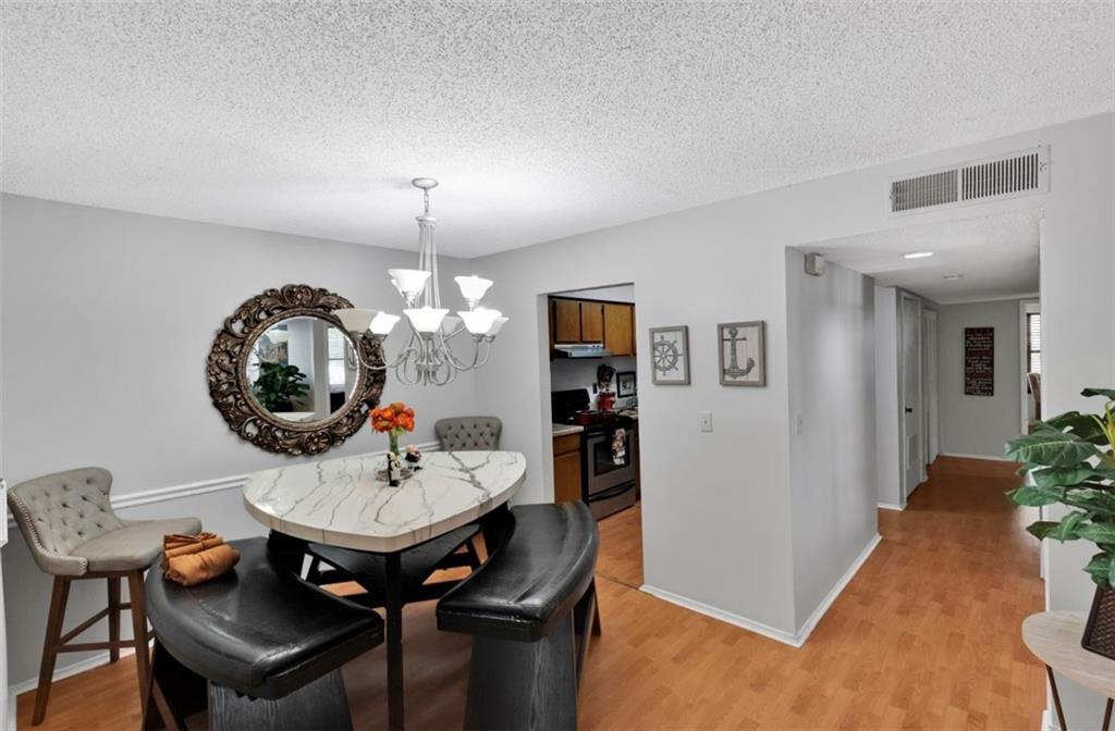 2411 Huntingdon, Unit 2411 Atlanta, GA 30350 - Photo 36 of 45 a dining room with a table and chairs