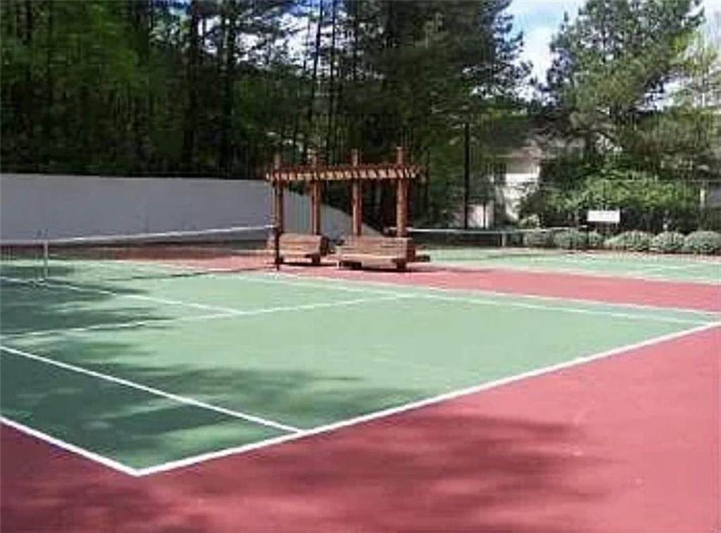 2411 Huntingdon, Unit 2411 Atlanta, GA 30350 - Photo 38 of 45 a view of a tennis ground with large trees
