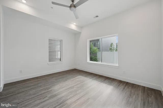 wooden floor in an empty room with a window
