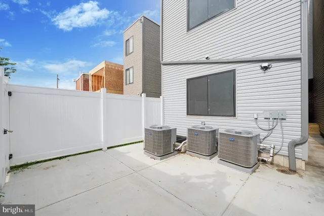 a couple of table and chairs in front of house