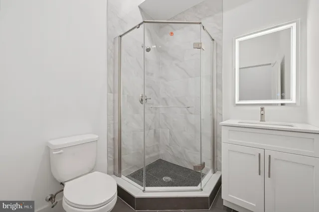 a bathroom with a shower a toilet and sink