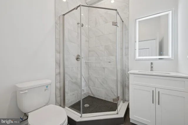 a bathroom with a shower a toilet and a sink