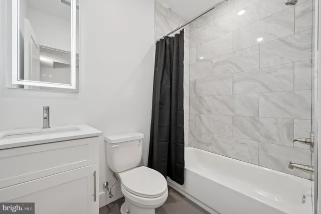 a bathroom with a toilet a sink and a bathtub