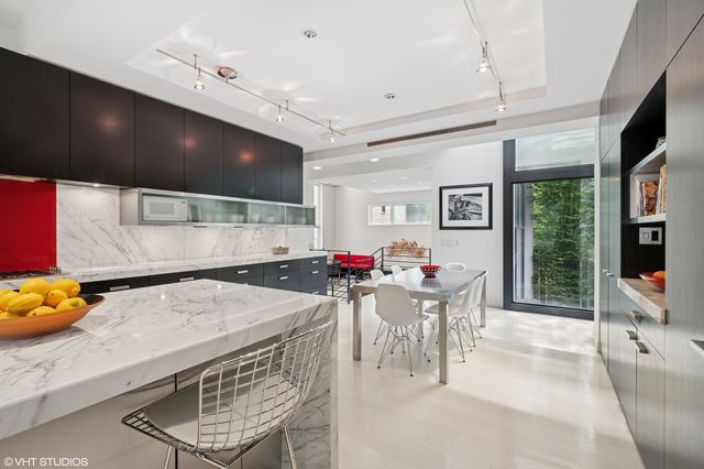 a view of a dining room with furniture a chandelier and flat screen tv