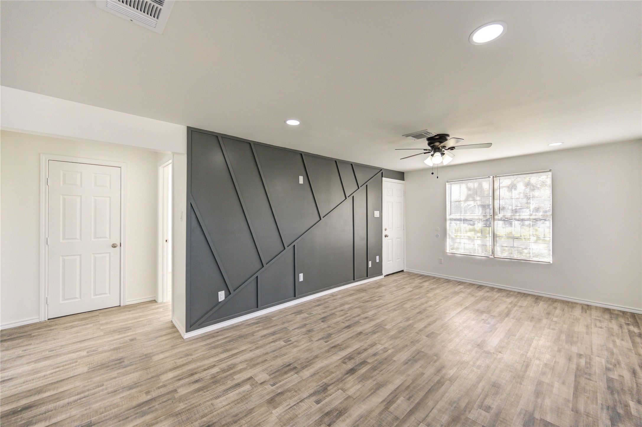 7811 St Louis Street Houston, TX 77028 - Photo 13 of 43 a view of an empty room with wooden floor and a window