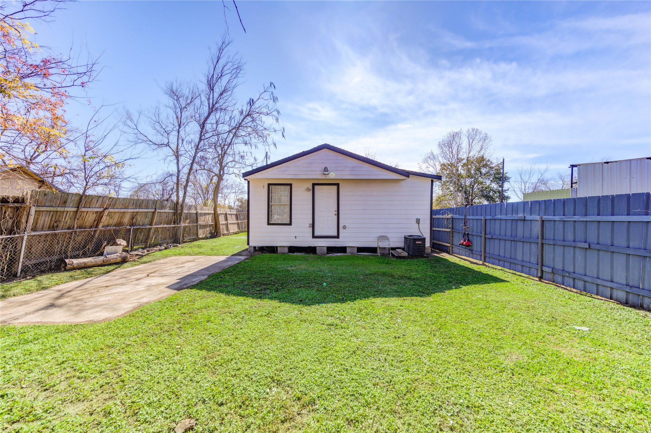 7811 St Louis Street Houston, TX 77028 - Photo 2 of 43 a view of backyard with wooden fence and large trees