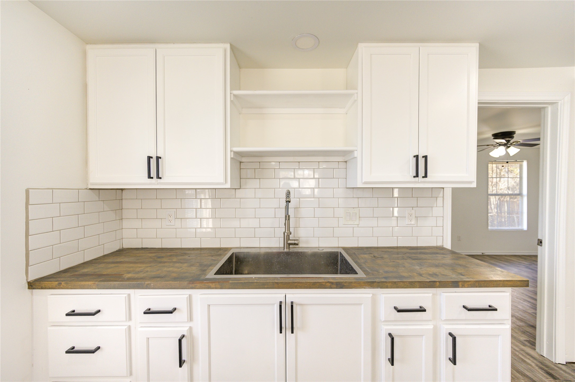7811 St Louis Street Houston, TX 77028 - Photo 22 of 43 a kitchen with granite countertop a sink a stove and cabinets