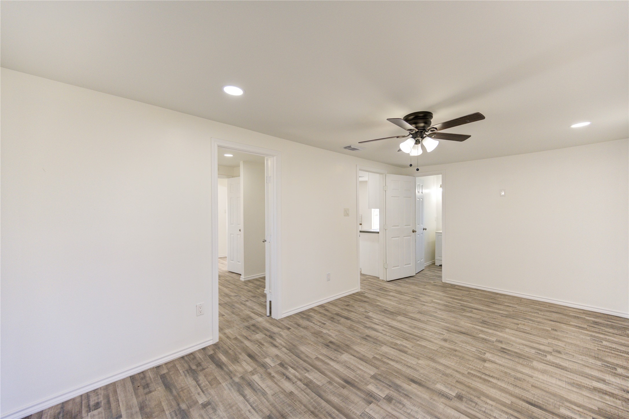 7811 St Louis Street Houston, TX 77028 - Photo 26 of 43 a view of an empty room with wooden floor and a ceiling fan