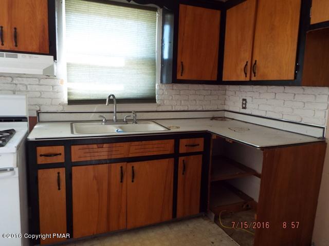 109 Perrin Avenue Shavertown, PA 18708 - Photo 3 of 13 a kitchen with stainless steel appliances granite countertop a sink stove and cabinets