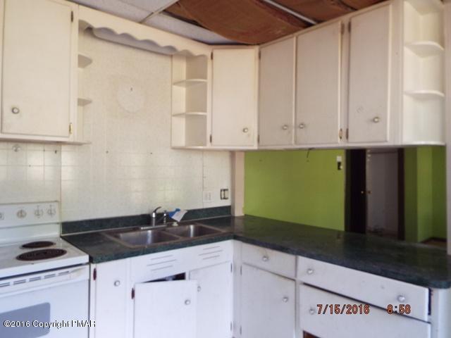 109 Perrin Avenue Shavertown, PA 18708 - Photo 4 of 13 a kitchen with granite countertop a sink and cabinets