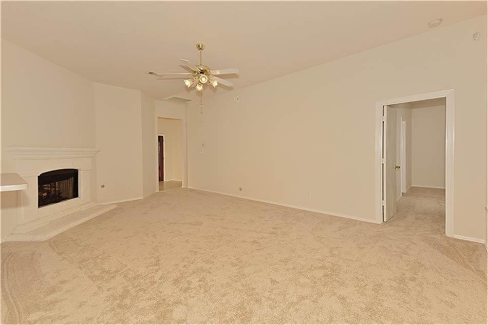 263 Adobe Terrace South Conroe, TX 77316 - Photo 12 of 23 an empty room with chandelier fan and windows