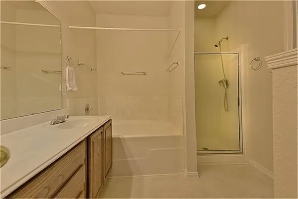 a bathroom with a shower and a sink