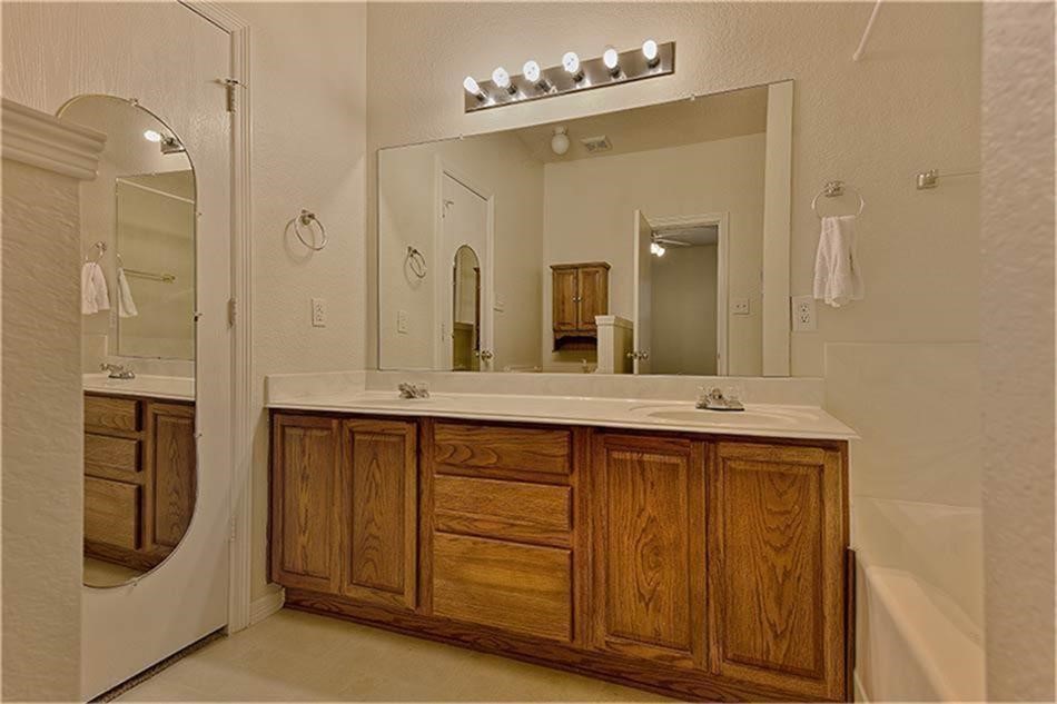 263 Adobe Terrace South Conroe, TX 77316 - Photo 16 of 23 a bathroom with a double vanity sink a mirror and a shower