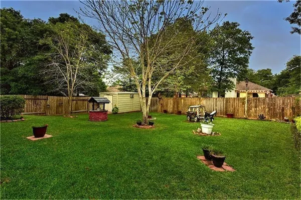 a view of a backyard with large trees