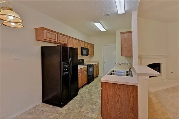 a kitchen with stainless steel appliances a refrigerator and a stove