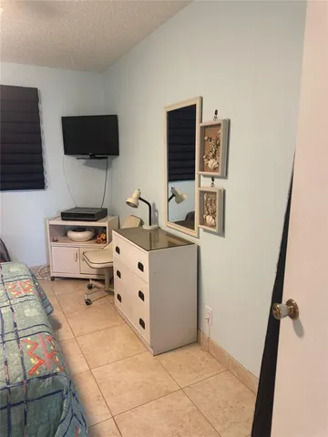 a room with a flat screen tv and a stove