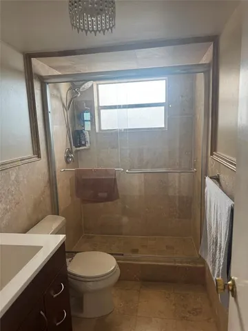 a bathroom with a toilet and a shower