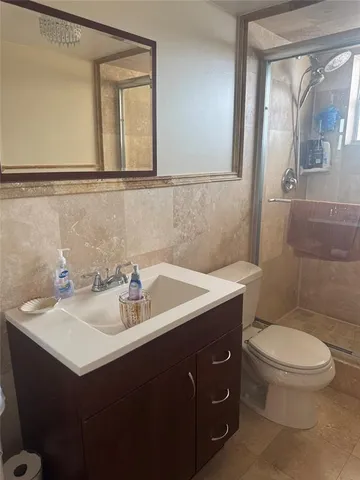 a bathroom with a sink toilet and mirror