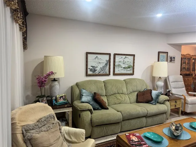 a living room with furniture and a mirror
