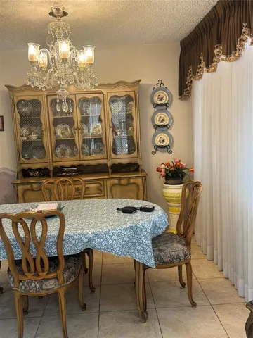 a dining room with furniture and chandelier