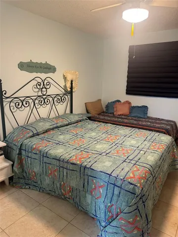 a bedroom with a bed and a lamp