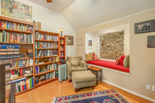 a living room with furniture and a book shelf