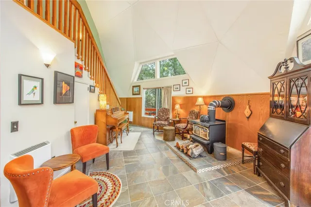 a living room with furniture a rug and a floor to ceiling window