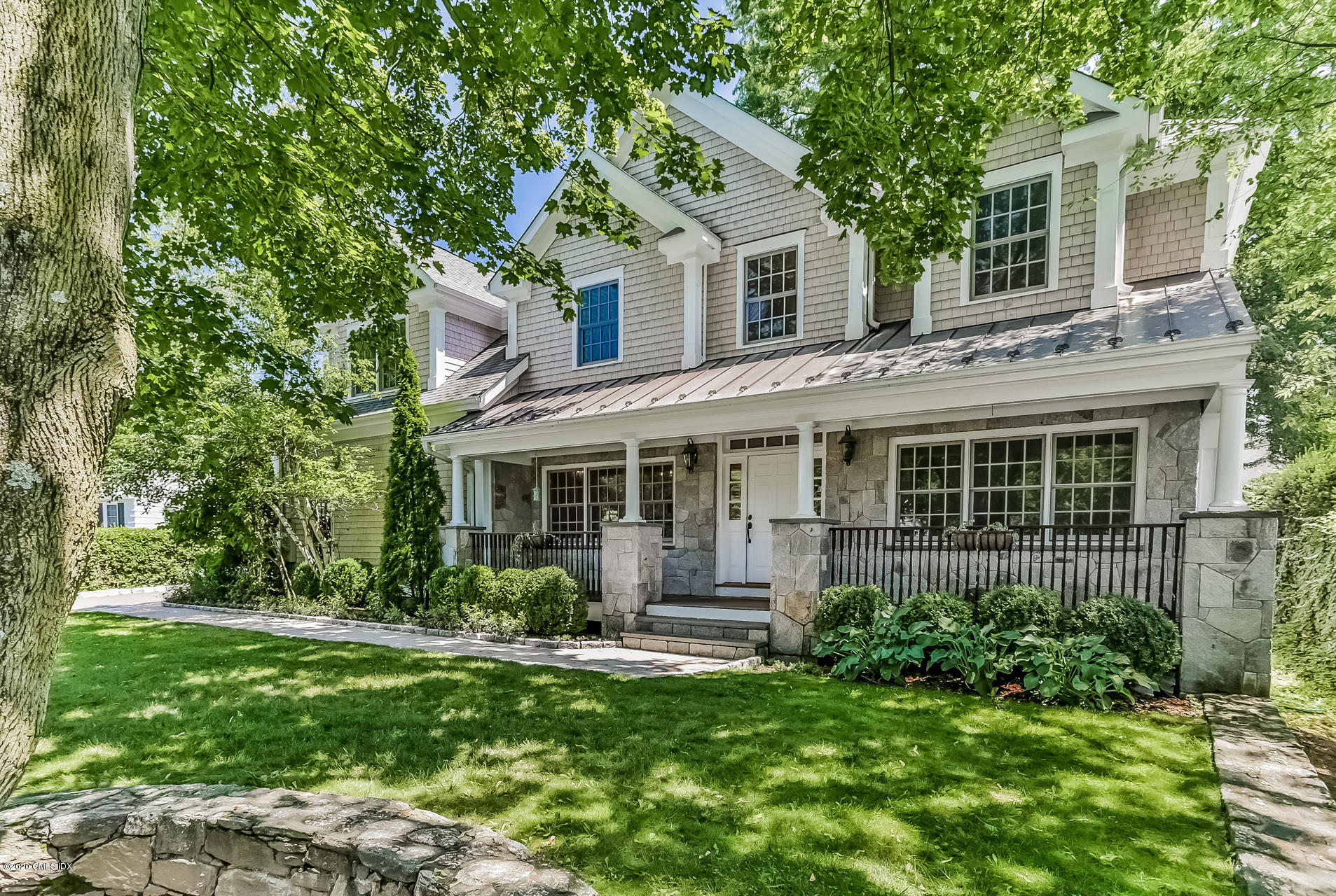 59 Riverside Lane Riverside, CT 06878 - Photo 1 of 21 a front view of a house with a yard and porch