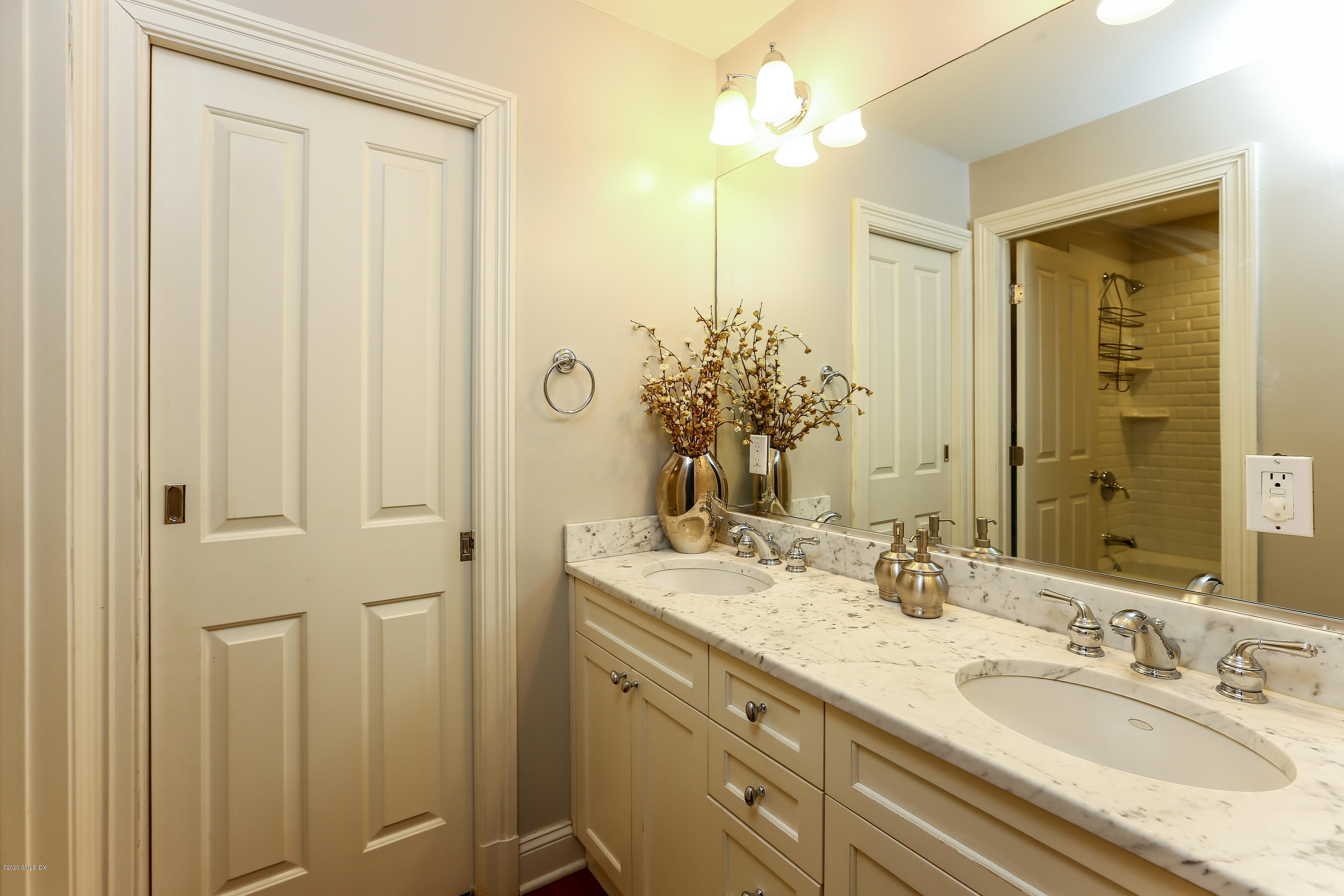 59 Riverside Lane Riverside, CT 06878 - Photo 13 of 21 a bathroom with a double vanity sink and a mirror