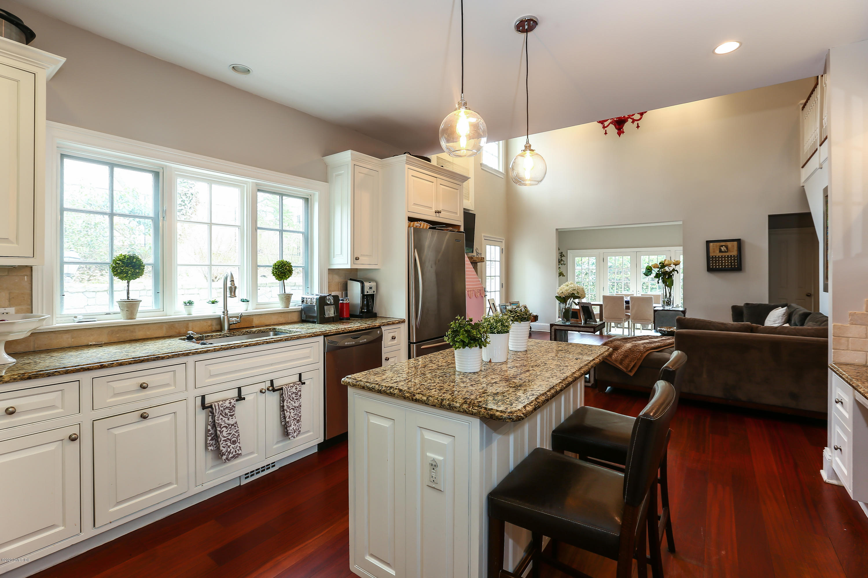 59 Riverside Lane Riverside, CT 06878 - Photo 6 of 21 a large kitchen with granite countertop a stove a sink a dining table and chairs